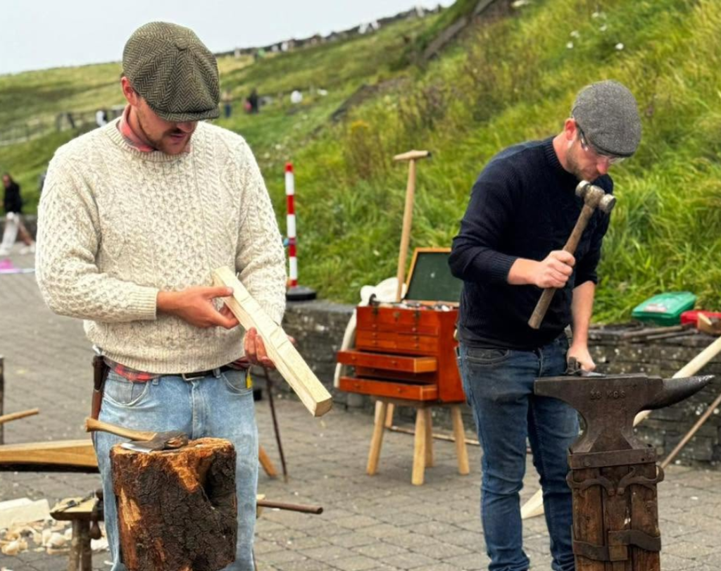 Image of the Travelling Tradesmen working with wood and metal at the Cliffs of Moher Experience.